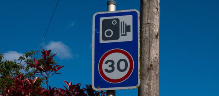 UK speed limit sign and speed camera warning