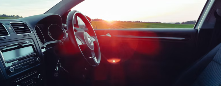 VW hire car on the road at sunset