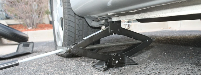 car with a flat tyre on a jack