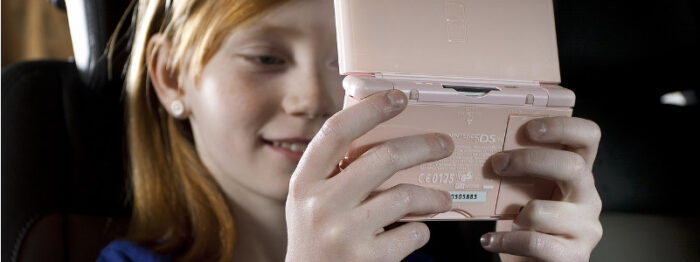 child using a game console in the car