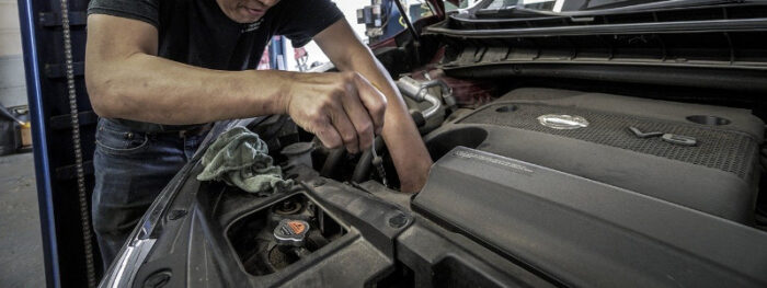 man doing basic car maintenance