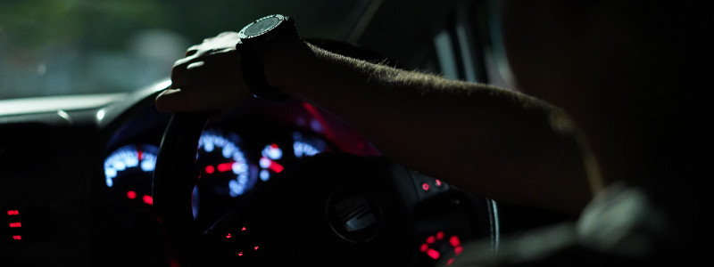 man driving at night suffering from driver fatigue