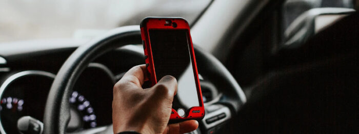 man using a phone in his car