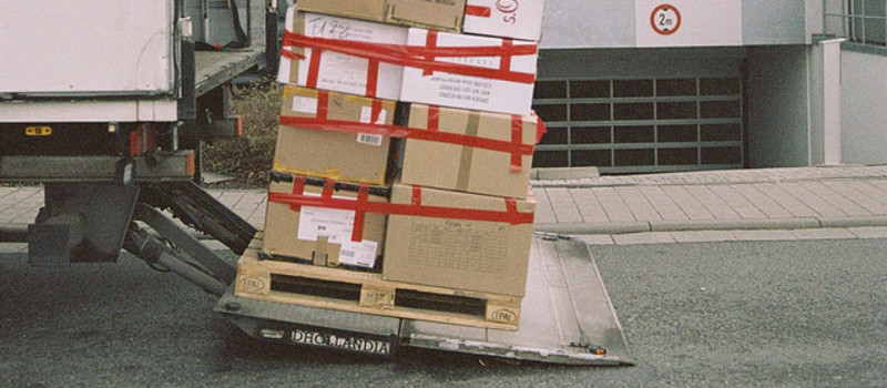 tail lift ful of heavy boxes at risk of overloading