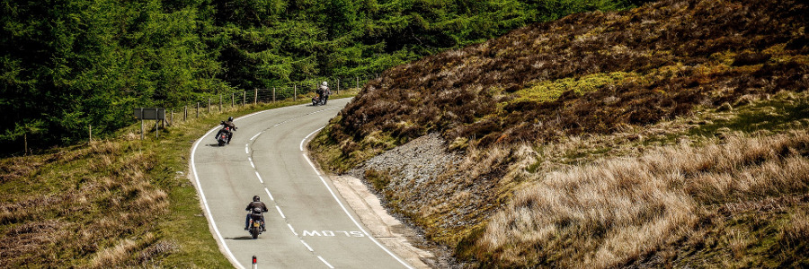 three motorbikes on a country road