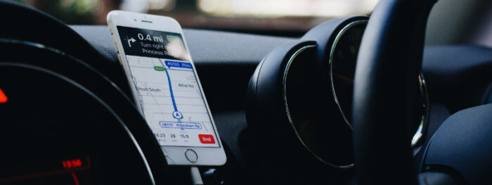 person in a vehicle using a sat nav while driving