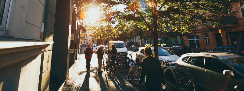van and cars using parking tips to park on a residential street