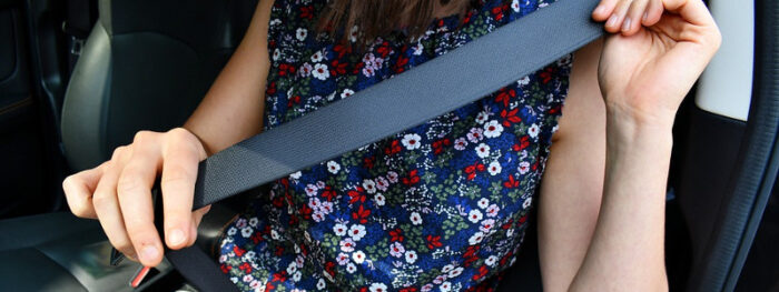 woman checking her seatbelt during MOT preparation