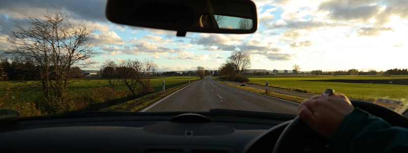 woman driving and following road trip tips