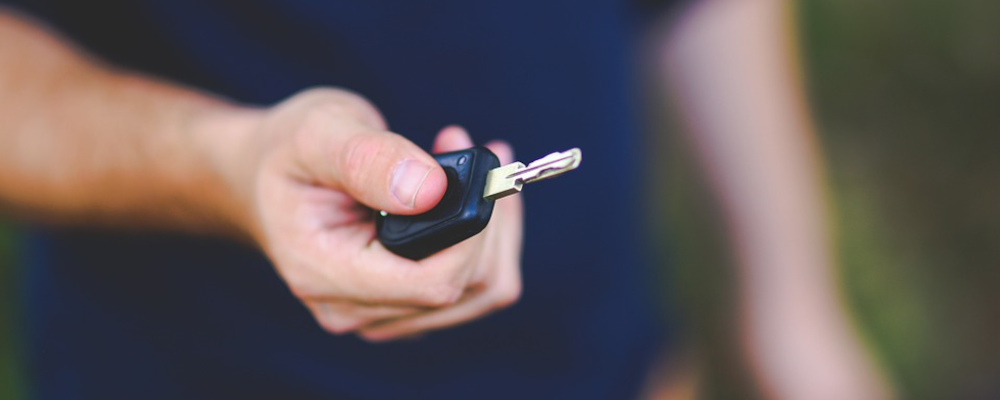 man holding a car key