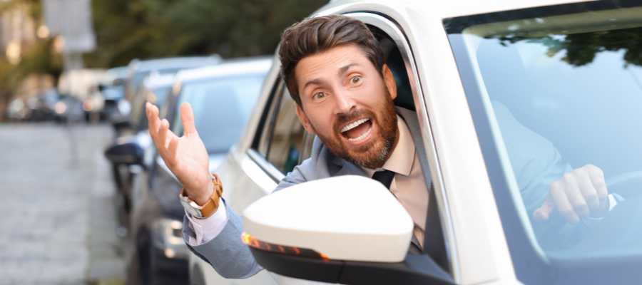 man annoyed at traffic in car