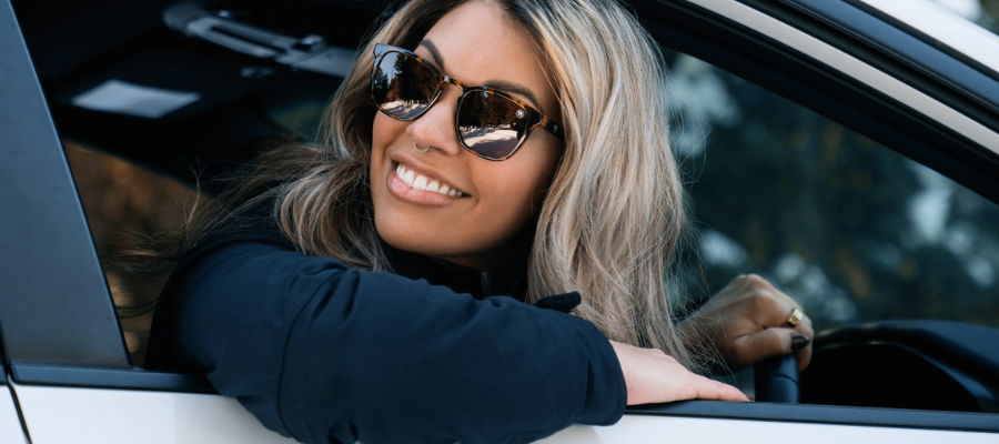 Woman driving car wearing sunglasses during the winter