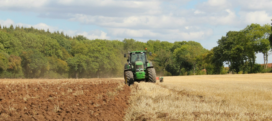 Tractor plowing a field in the British countryside